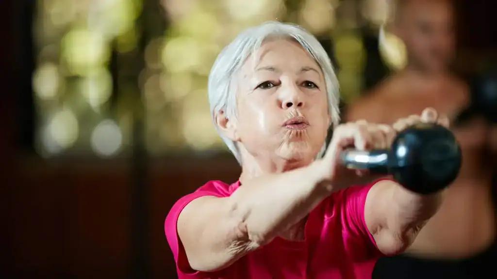 Older woman doing weight training Newark-on-Trent to help her strength and longevity 